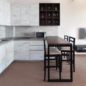 a kitchen with a table and chairs in a room at Altezza Premium Breathtaking Sea Views in Budva