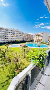 a view of a swimming pool from a balcony of a apartment at DELUX Salou in Salou