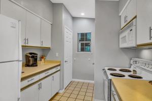 a kitchen with white cabinets and a stove at Fairway Heights condo in Branson