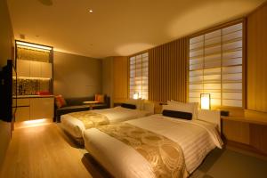a hotel room with two beds and a window at Kanazawa Tokyu Hotel in Kanazawa