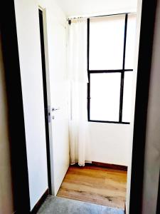 an empty room with a window and a door at Apartment 1913 in Ponticelli +19 photos