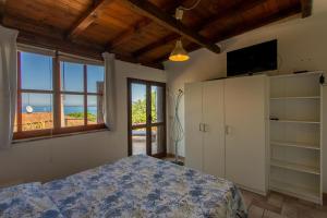a bedroom with a bed and a large window at Fortino's Hause in Porto Santo Stefano +40 photos