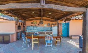 a kitchen and dining room with a wooden table and chairs at Fortino's Hause in Porto Santo Stefano