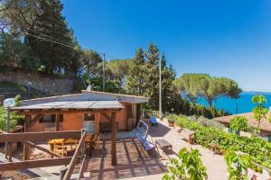 a small house with a view of the water at Fortino's Hause in Porto Santo Stefano