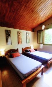 a bedroom with two beds in a room at La Caz'Anna in Cilaos