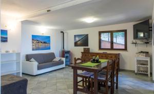 a living room with a table and a couch at Fortino's Hause in Porto Santo Stefano