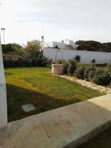 a yard with a statue in the grass at Villa Anna Maria in Polignano a Mare