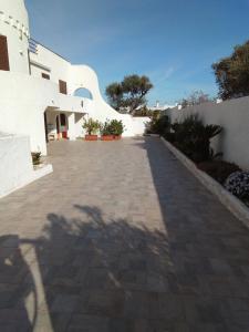 a shadow of a tree on a brick driveway at Villa Anna Maria in Polignano a Mare