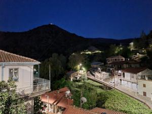 a view of a town at night with a mountain at Elpiniki's Old House in Kalopanayiotis