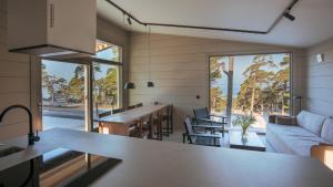 a kitchen and living room with a couch and a table at Vidhave in Visby