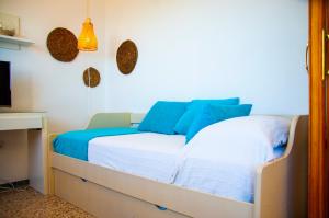 une chambre avec un lit avec des draps bleus et blancs dans l'établissement Arena y el Mar, à Famara