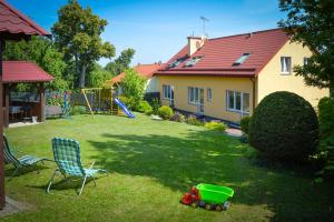 a yard with a toy car and a chair and a house at Pokoje u Basi Glamping Mikołajki in Mikołajki