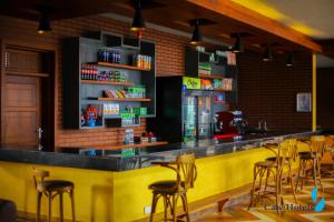 a restaurant with a yellow bar with stools at Cate Hotel Morogoro in Morogoro