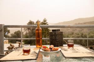 a bottle of alcohol and a plate of food on a table at Square Apartment in Kambanós
