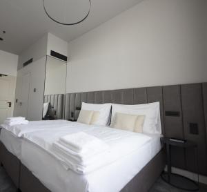 a large white bed with white sheets and pillows at The Gold Bank in Prague