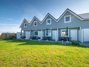a large house with a lawn in front of it at Domki Turkusowe Zacisze in Sarbinowo