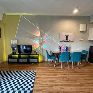 a dining room with a table and blue chairs at Kaw Supreme Theme WIFI Luxury 7 PAX Genting Pool & Mountain View Cuti Genting Homestay Midhills in Genting Highlands