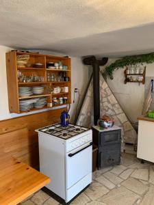 a kitchen with a stove and a stove top oven at Agro privat in Hrabušice