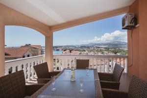 a table with wine glasses on a balcony at Plava Adria Podstrana in Podstrana