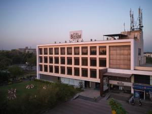 a building with a sign on the top of it at Pride Biznotel Manjusar Vadodara in Vadodara
