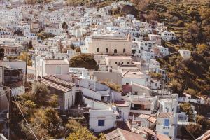 an aerial view of a town with white buildings at House above the castle in Ioulida