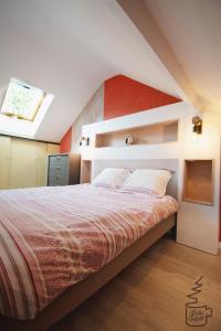 a bedroom with a large bed with a red wall at Studio Juliette in Stavelot