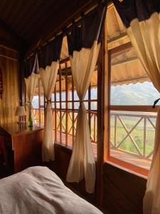 a bedroom with a bed and a large window at Sapa's Soul in Sa Pa