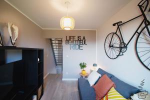 a living room with a bike hanging on the wall at Studio Juliette in Stavelot