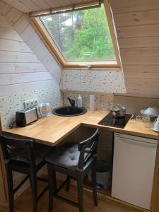 a kitchen with a counter with a sink and a window at Beautiful view in Nida