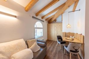 a living room with a couch and a table at Le Suite della nonna Teresina in Moena
