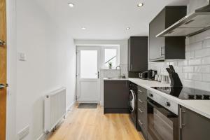 cocina con fregadero y lavavajillas en Luxnightzz - Stylish Boutique 1 Bed Apartment, en Gravesend