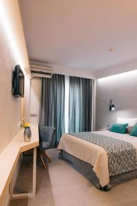 Postel nebo postele na pokoji v ubytování Minoa Hotel