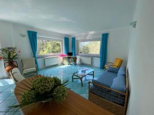a living room with a couch and a table at Le Dimore di Zaro - Green Paradise in Forio d'Ischia