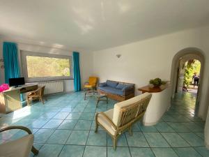 a living room with a couch and a table at Le Dimore di Zaro - Green Paradise in Forio d'Ischia
