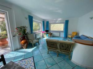 a living room with a couch and a table at Le Dimore di Zaro - Green Paradise in Forio d'Ischia