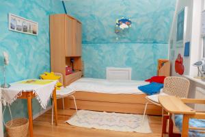 a bedroom with a bed and a table and chairs at Haus Haeger in Dahme