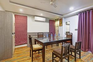 a dining room with a table and chairs at Itsy By Treebo - Ransu Residency in Guwahati