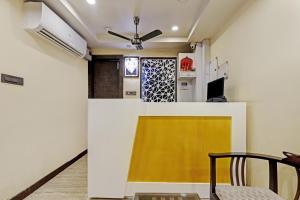 a living room with a yellow and white wall at Itsy By Treebo - Ransu Residency in Guwahati