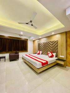 a bedroom with a large bed and a couch at The Eleganza in Jhājra +87 photos