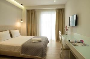 Postel nebo postele na pokoji v ubytování Hotel Vila Kalcuni Sarande