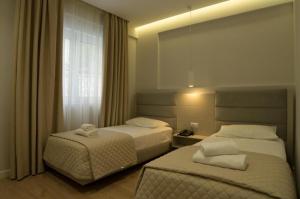 Postel nebo postele na pokoji v ubytování Hotel Vila Kalcuni Sarande