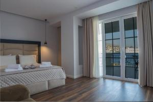 Postel nebo postele na pokoji v ubytování Hotel Vila Kalcuni Sarande
