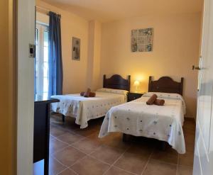 Postel nebo postele na pokoji v ubytování Apartamentos San Bruno Canela