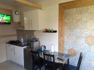 a small kitchen with a table and a microwave at Domek nad Szelągiem in Stare Jabłonki
