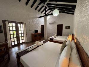 a living room with two beds and a couch at Casa Amihan in Anda