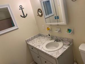 a bathroom with a sink and a mirror at Michaels -Beachside Bungalows in St Pete Beach