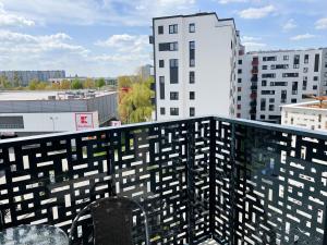 a balcony with a view of some buildings at South4You Apartments in Wrocław