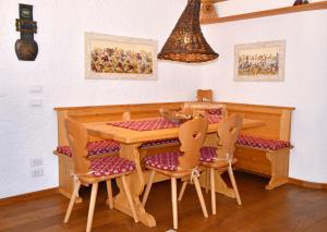 a dining room with a wooden table and chairs at Casa MARGHERITA Rainalter in Madonna di Campiglio