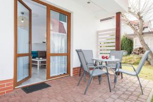 a patio with a table and chairs on a patio at Jaśmin in Rowy