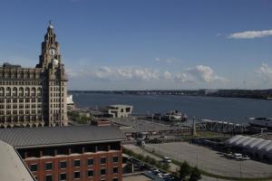 a view of a city with a clock tower and a river at Liver View Apartments in Liverpool